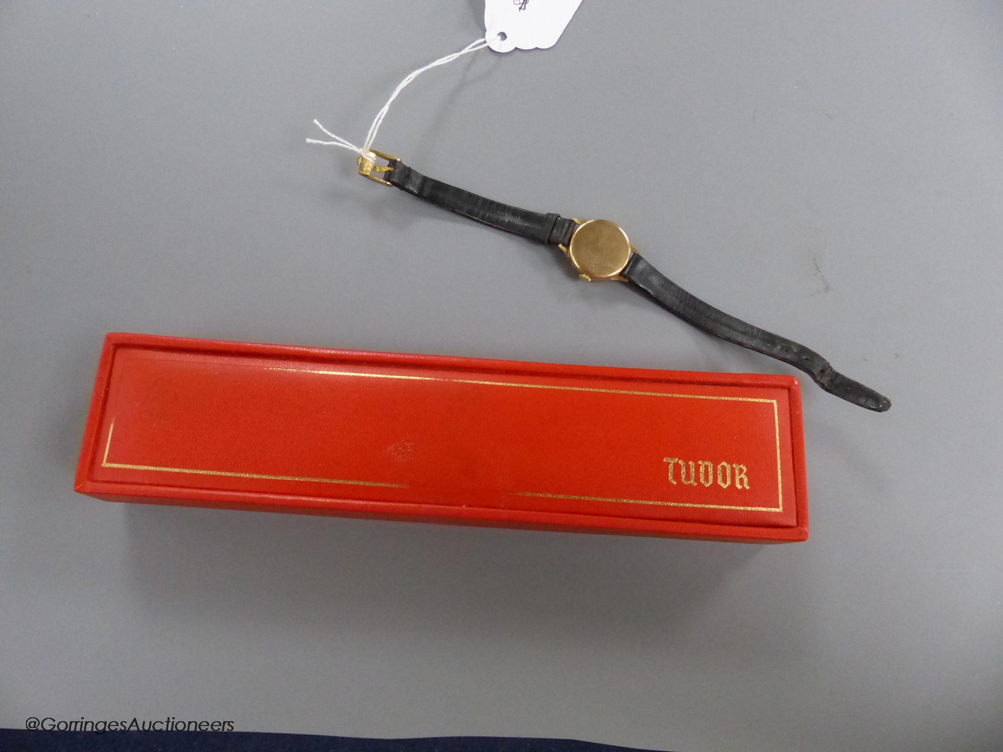 A lady's 9ct gold Tudor manual wind wrist watch, with subsidiary seconds, on a leather strap, with gold plated Rolex buckle, with Tudor box.